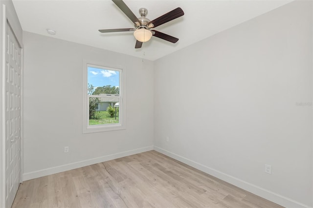 spare room featuring ceiling fan and light hardwood / wood-style flooring