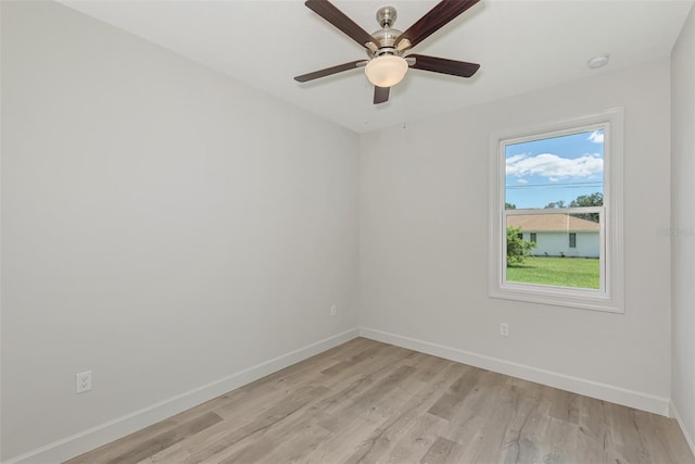 spare room with ceiling fan and light wood-type flooring