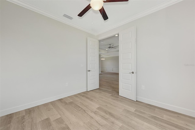 spare room featuring ceiling fan, ornamental molding, and light hardwood / wood-style floors