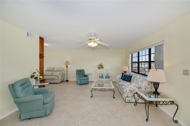 tiled living room with ceiling fan