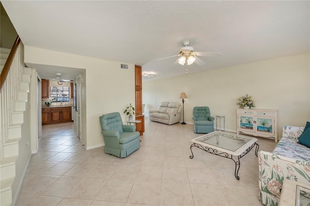 tiled living room with ceiling fan