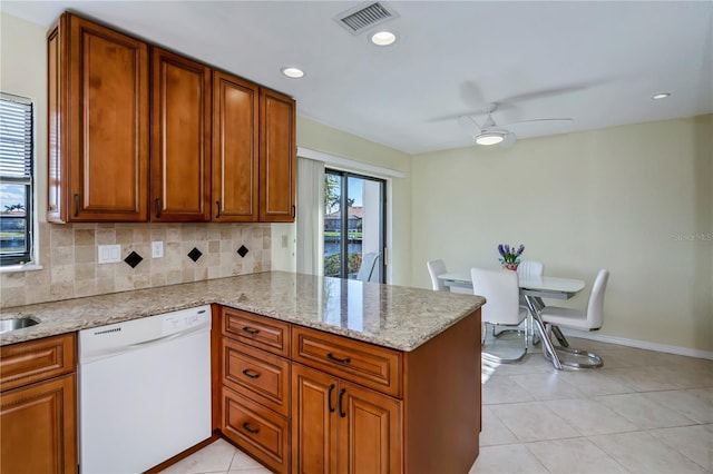 kitchen featuring light stone counters, light tile patterned floors, white dishwasher, kitchen peninsula, and ceiling fan