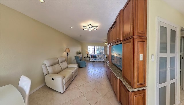 living room with ceiling fan and light tile patterned floors