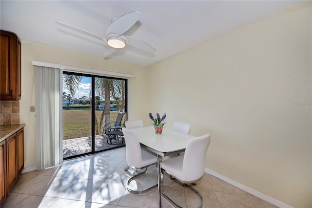 dining space with ceiling fan and light tile patterned floors