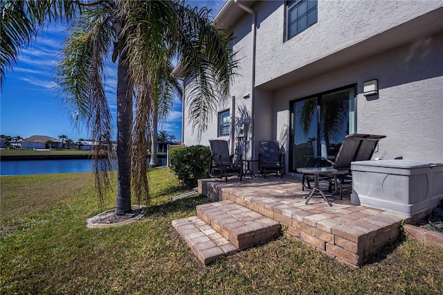 view of yard featuring a patio area and a water view