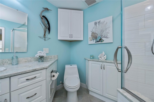 bathroom with vanity, tile patterned flooring, a shower with door, and toilet