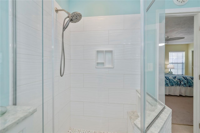 bathroom featuring ceiling fan and a tile shower