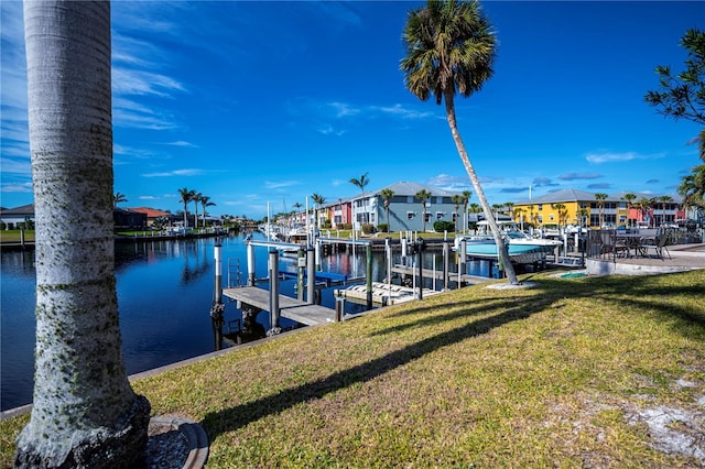 view of dock featuring a yard and a water view