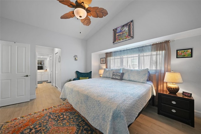 bedroom featuring ensuite bath, ceiling fan, high vaulted ceiling, a closet, and light wood-type flooring