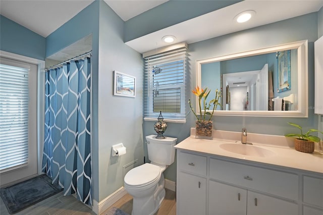 bathroom with a shower with curtain, vanity, wood-type flooring, and toilet