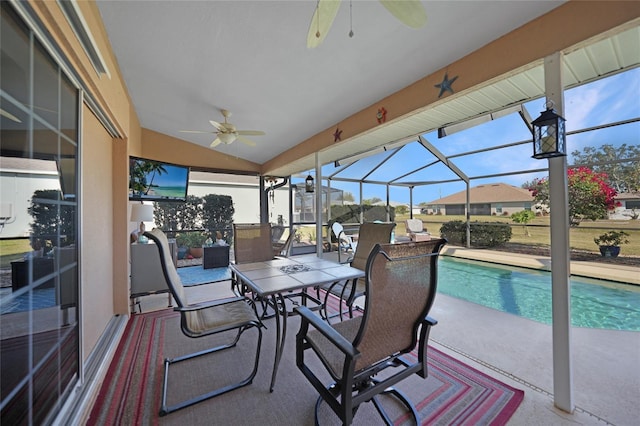 view of swimming pool featuring ceiling fan, glass enclosure, and a patio area