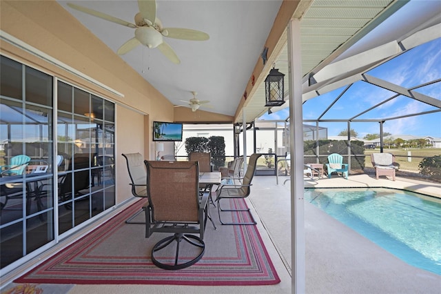 view of swimming pool with ceiling fan, glass enclosure, and a patio area