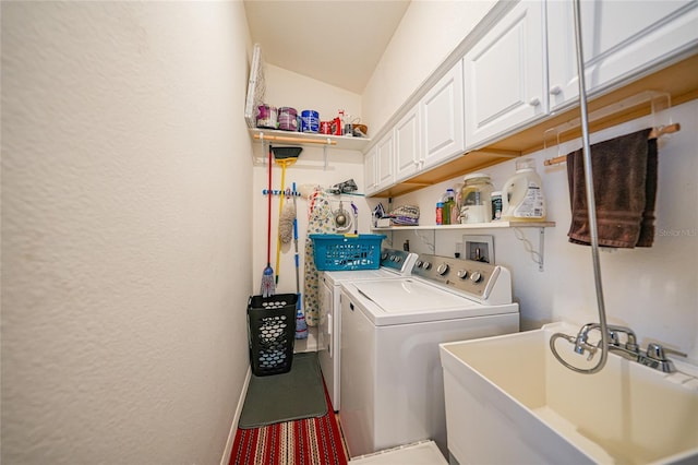 washroom featuring sink, cabinets, and washer and dryer