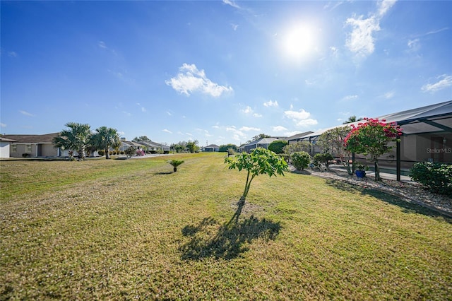 view of yard with glass enclosure