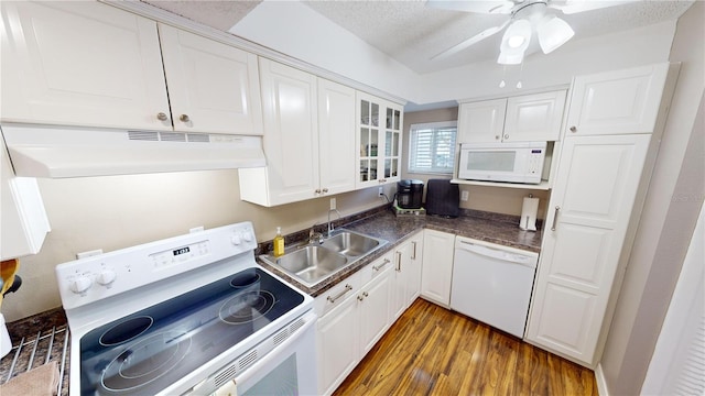 kitchen featuring white appliances, dark hardwood / wood-style flooring, sink, and white cabinets