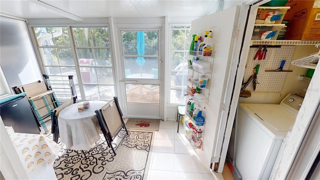 sunroom / solarium featuring washer / clothes dryer and a wealth of natural light