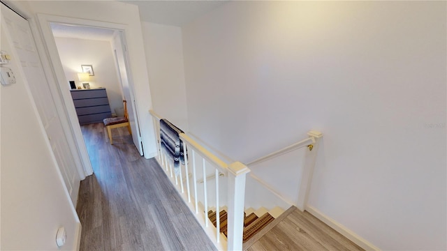 stairs featuring hardwood / wood-style flooring