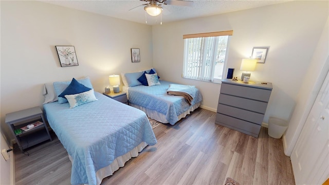 bedroom with ceiling fan and light wood-type flooring