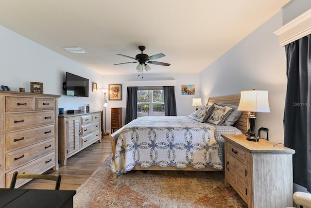 bedroom with hardwood / wood-style flooring and ceiling fan