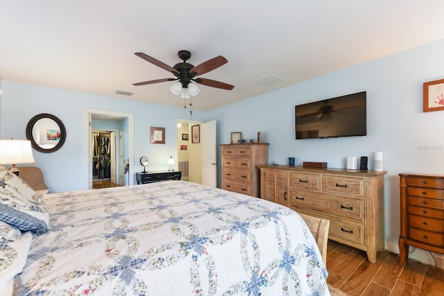 bedroom with a spacious closet, a closet, and ceiling fan