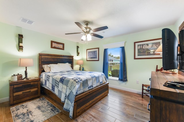 bedroom with hardwood / wood-style floors and ceiling fan