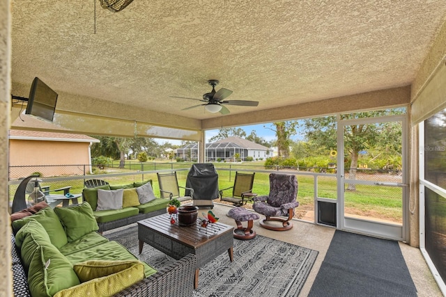 sunroom featuring ceiling fan and a healthy amount of sunlight