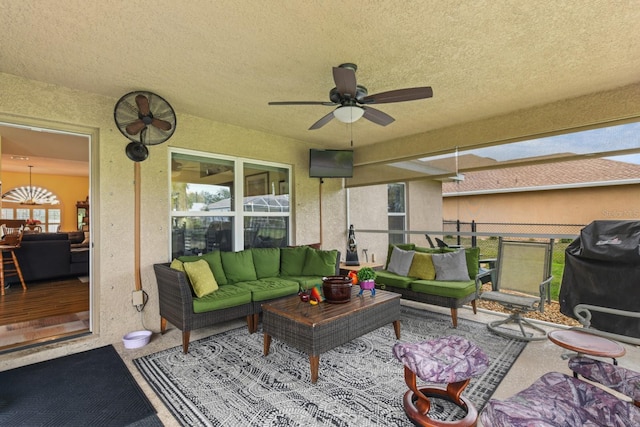 view of patio with ceiling fan, an outdoor living space, and a grill