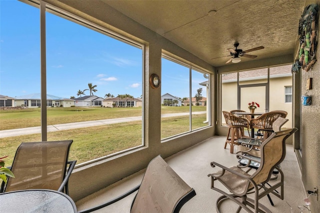 sunroom featuring ceiling fan