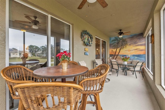 sunroom / solarium featuring ceiling fan