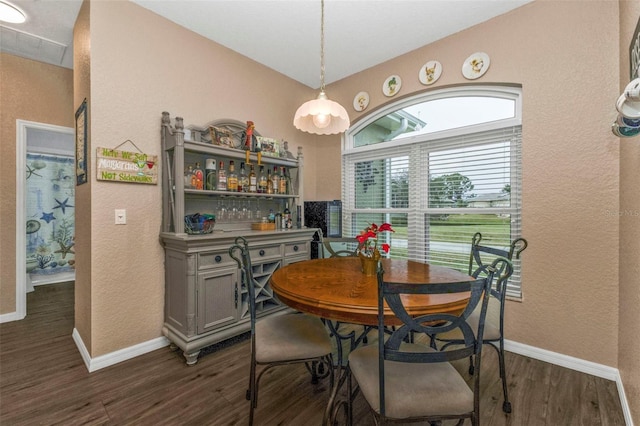 dining space with dark wood-type flooring