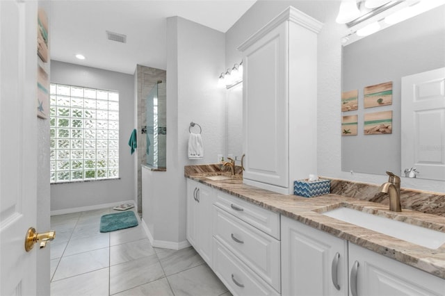 bathroom with vanity and tiled shower