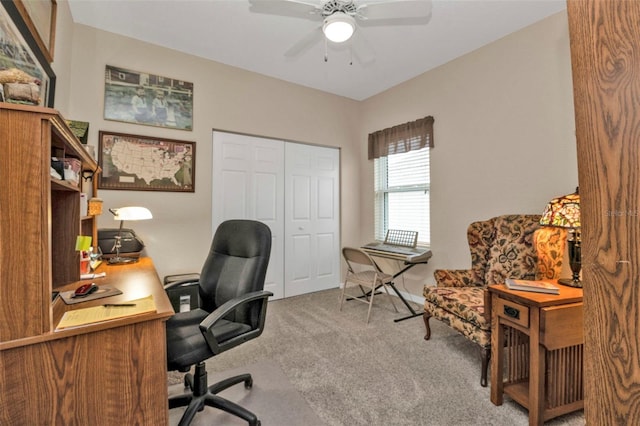 carpeted office space with ceiling fan