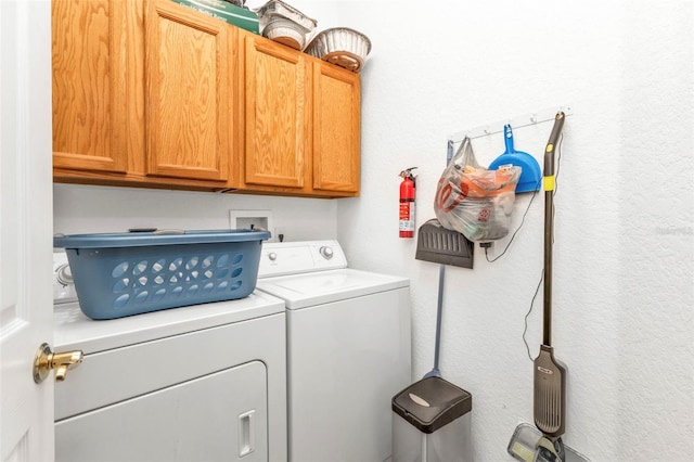 laundry area featuring cabinets and washer and clothes dryer