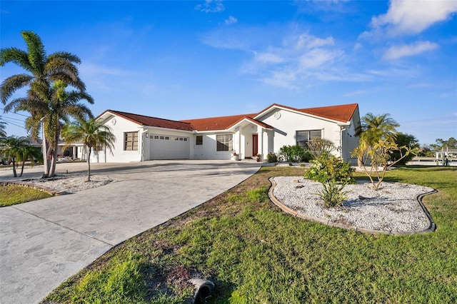 view of front of house with a garage and a front lawn