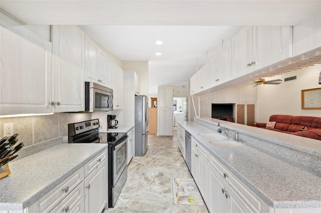 kitchen featuring white cabinetry, sink, and appliances with stainless steel finishes