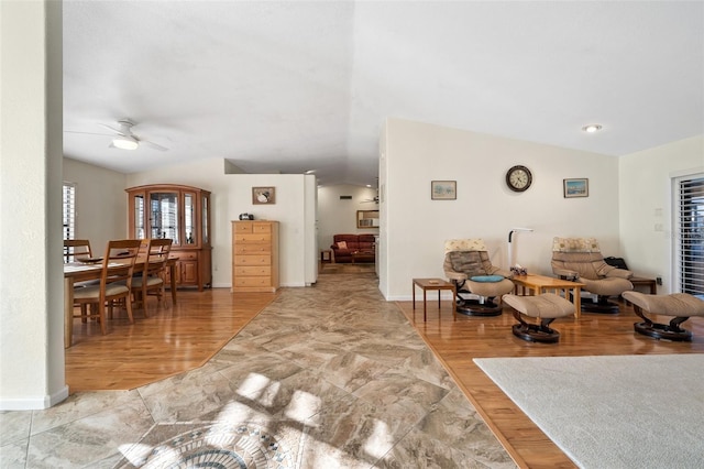 living room featuring vaulted ceiling, hardwood / wood-style floors, and ceiling fan