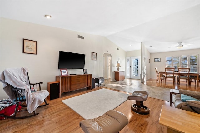 living room with vaulted ceiling, light hardwood / wood-style floors, and ceiling fan