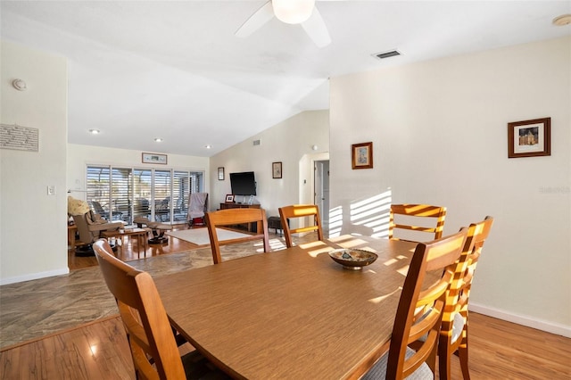 dining space featuring vaulted ceiling, ceiling fan, and light hardwood / wood-style floors