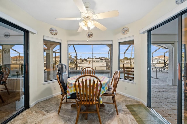 sunroom featuring ceiling fan