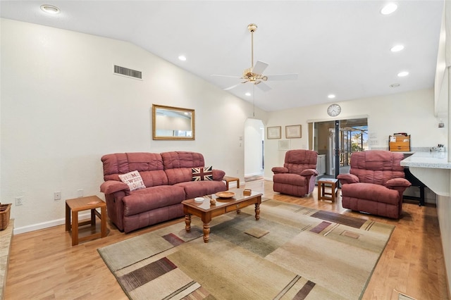 living room with vaulted ceiling, ceiling fan, and light hardwood / wood-style flooring