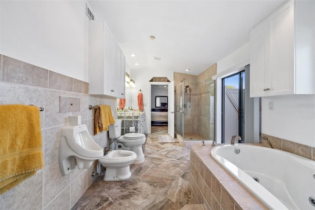 bathroom with a bidet, tile walls, toilet, and separate shower and tub