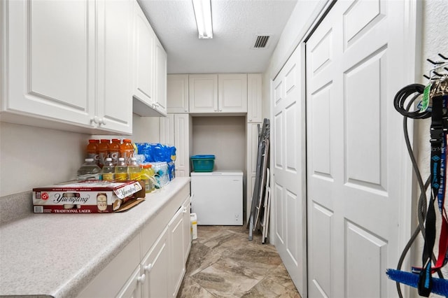 laundry room with a textured ceiling