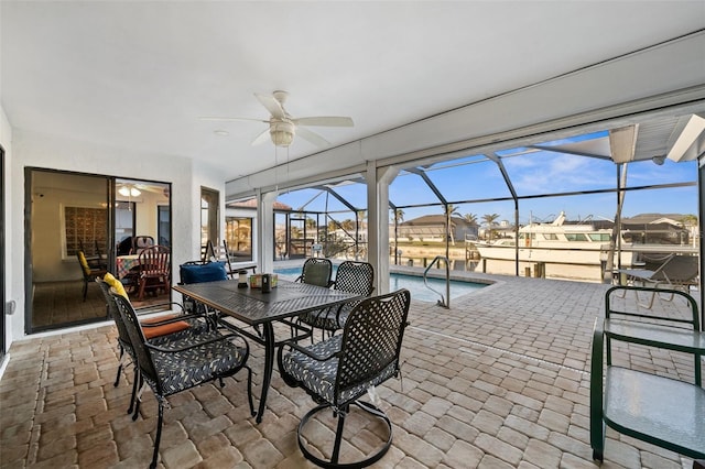 sunroom featuring ceiling fan