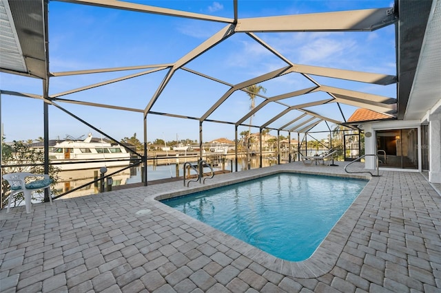 view of swimming pool with a lanai, a patio, a boat dock, and a water view