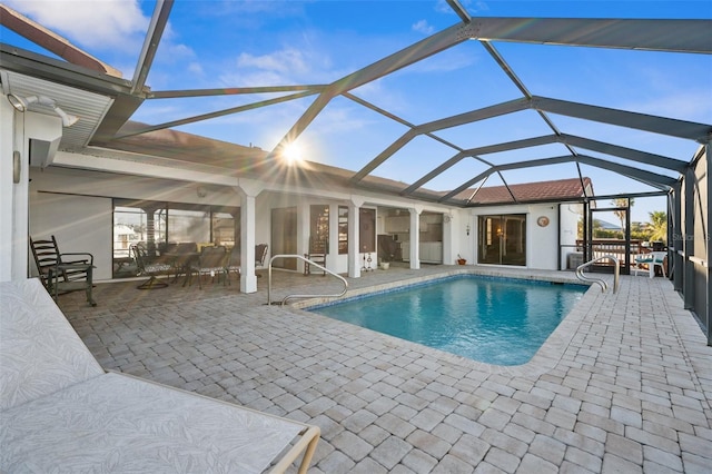 view of swimming pool with a lanai and a patio area