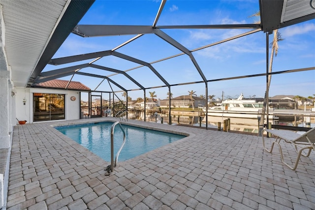 view of pool featuring a water view, a lanai, a boat dock, and a patio area