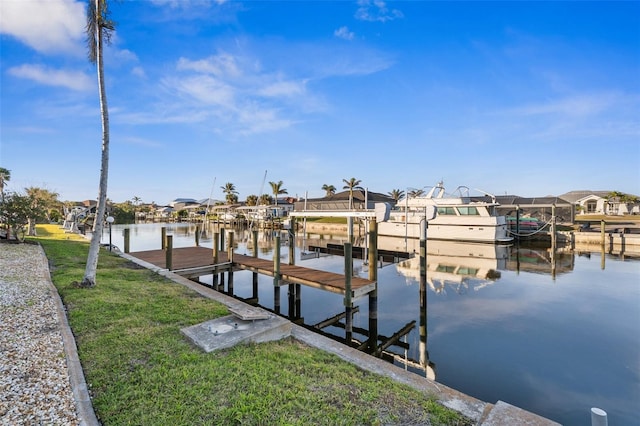 view of dock featuring a water view and a lawn