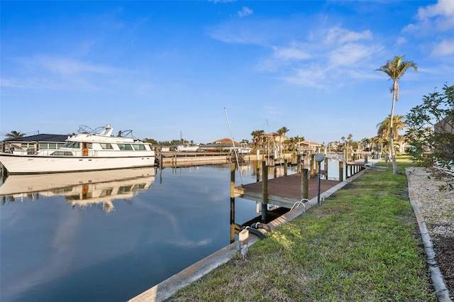 dock area with a water view and a yard