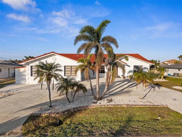 mediterranean / spanish home with a front lawn