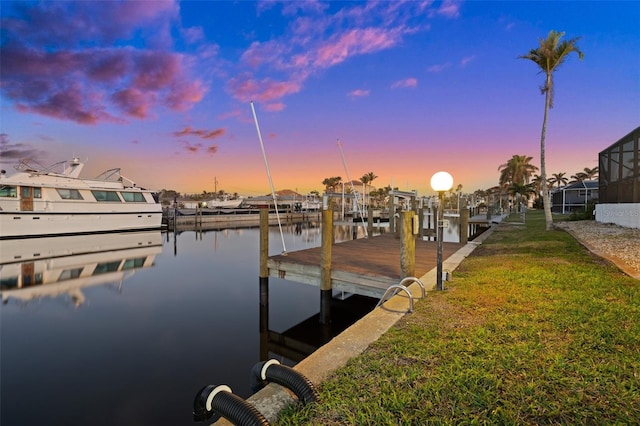 view of dock featuring a water view and a lawn